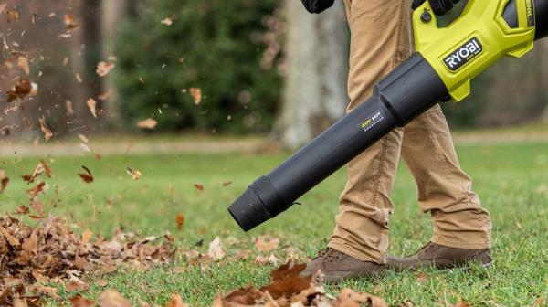 person using 40v ryobi blower on leaves in yard