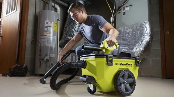 man using 6 gallon wet-dry vacuum